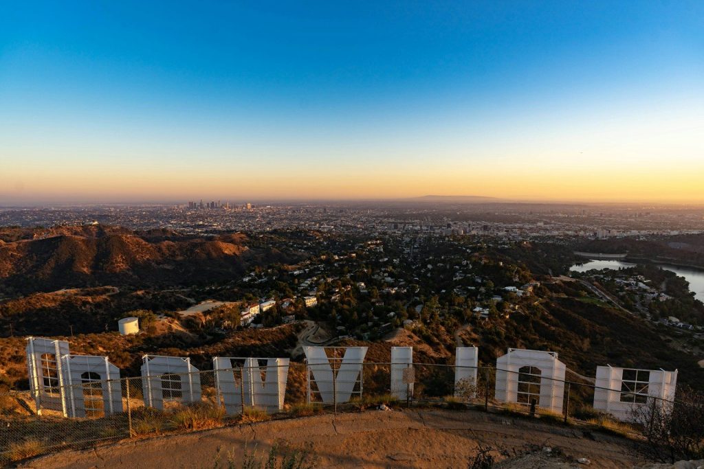 a view of a city from a hill top behind the Hollywood sign looking into LA